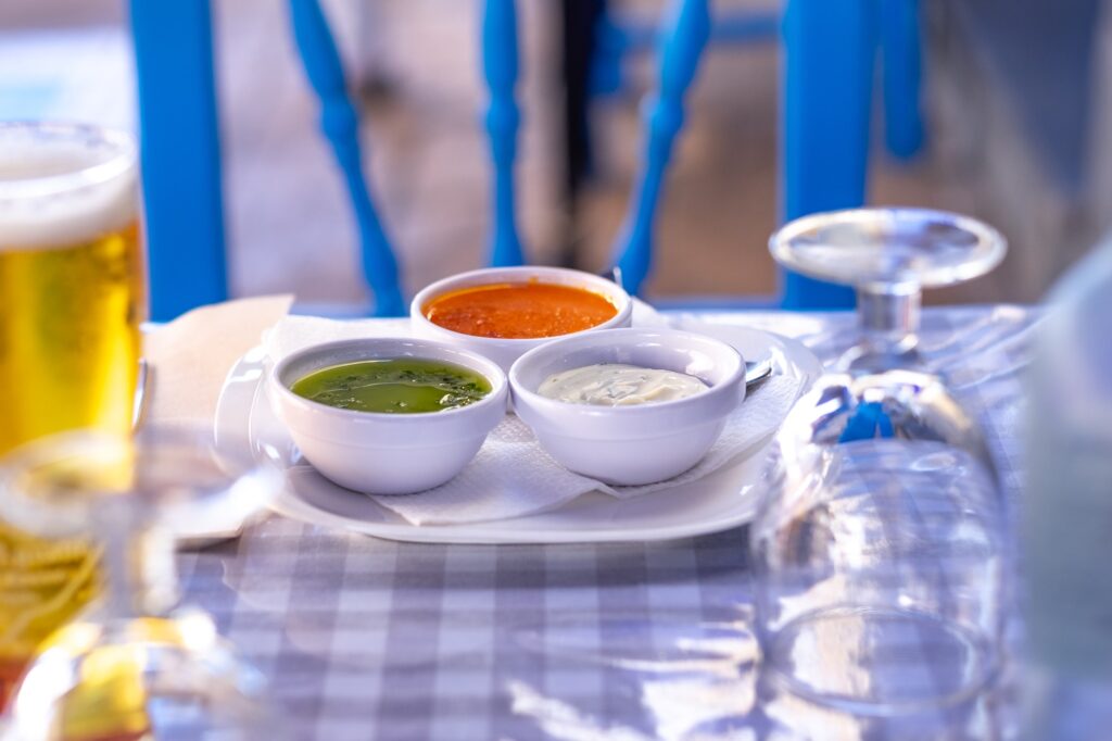 Restaurant table with three typical sauces of the Canary Islands, called "mojo"